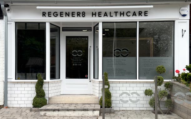 The outside of the Regener8 Healthcare clinic. It is a white building with a tiled exterior and large glass windows.