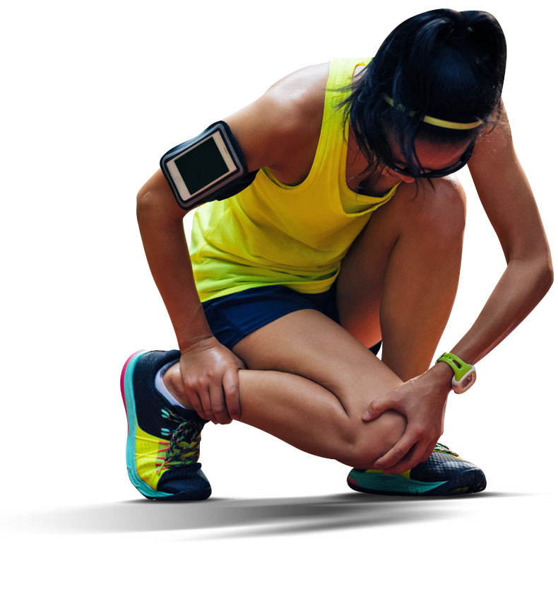 Image of a young female runner crouching down holding her knee and ankle in pain